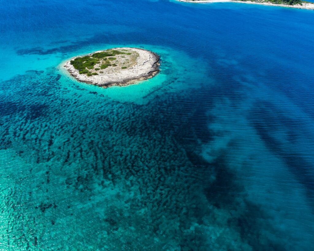 Aerial view of Proizd Island Croatia showing turquoise swimming coves and pristine rocky coastline