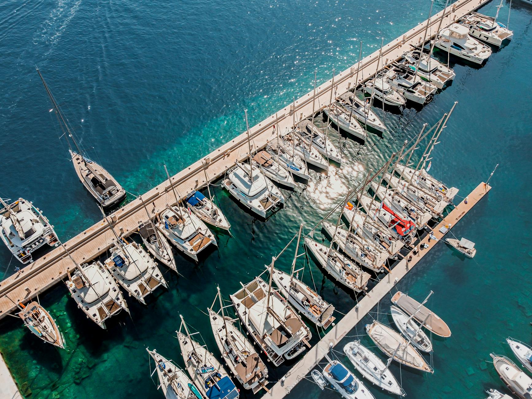Aerial view of yacht marina berths in Croatia showing aligned luxury yachts